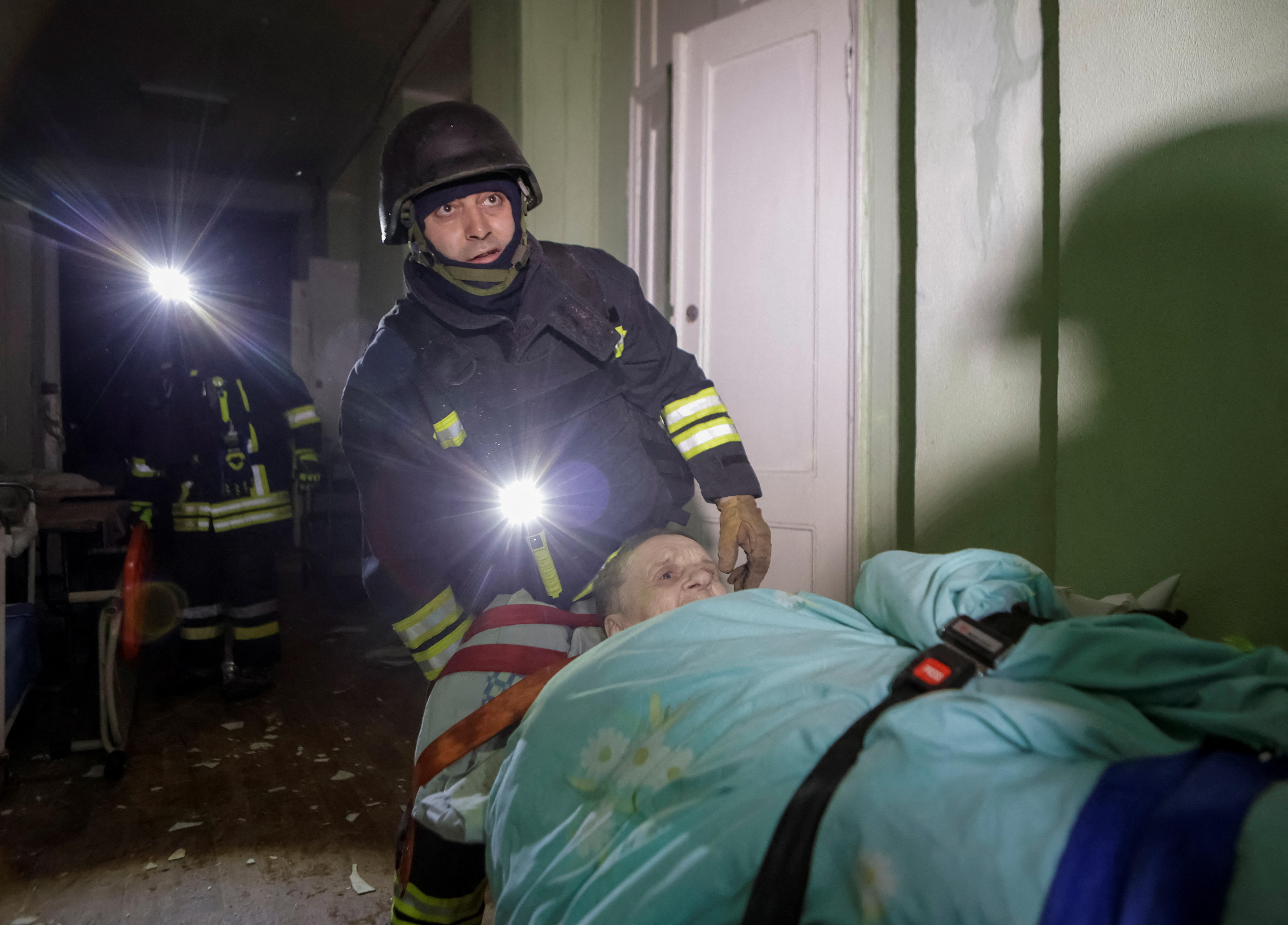 A patient being loaded on a stretcher into an ambulance in Kharkiv.