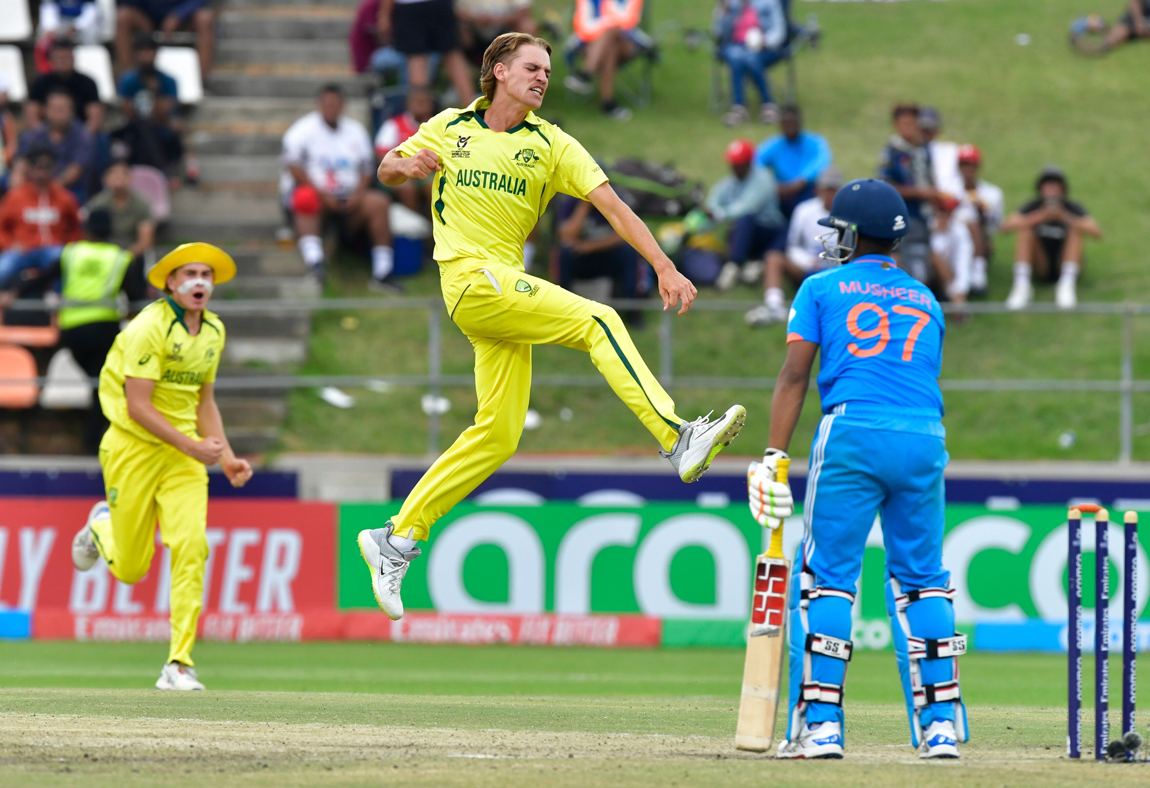 Mahli Beardman leaps into the air in celebration as an Indian batter looks disappointed