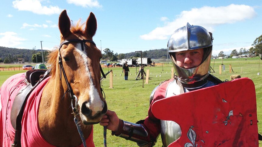 Jouster Justin Holland in costume with horse at the Tasmanian Medieval Festival.
