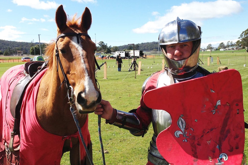 Jouster Justin Holland in costume with horse at the Tasmanian Medieval Festival.