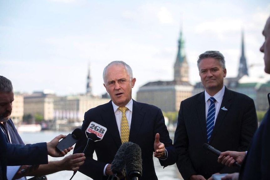 Malcolm Turnbull speaks to the media with Matthias Cormann in Hamburg ahead of the G20.