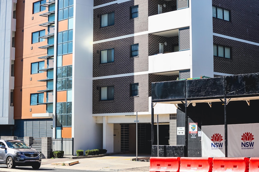 Exterior of an apartment block with a building site next door. 