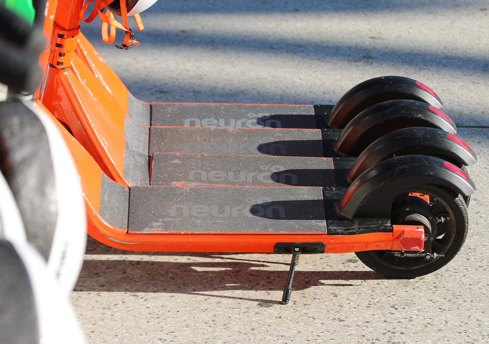 A line up of Neuron electric scooters
