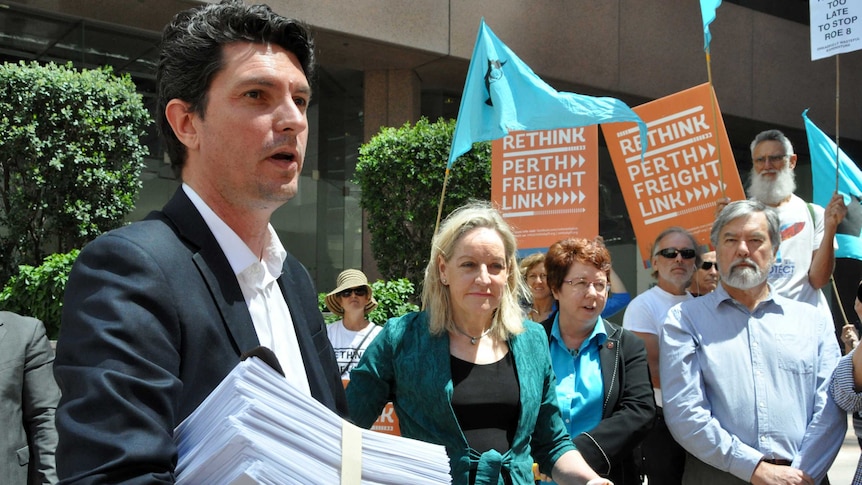Greens Senator Scott Ludlam joins a rally outside the Prime Minister's Perth office.