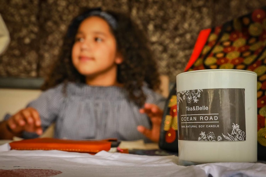 Téa Devow is sitting with a few of the products from her small business.