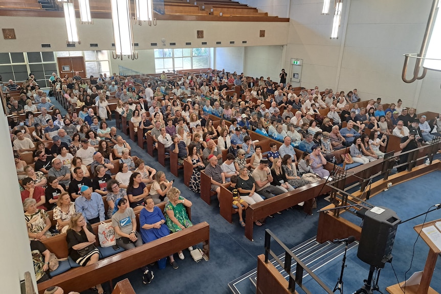 members of the jewish community sitting down at the North Shore Synagogue in lindfield sydney