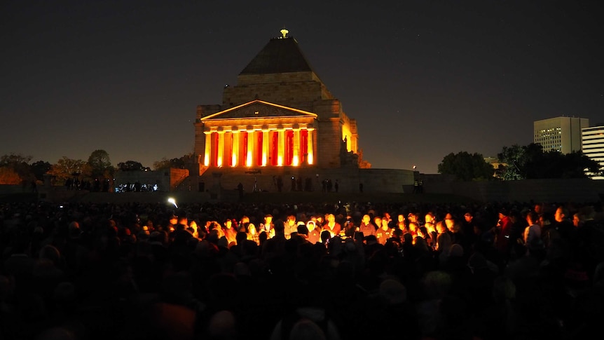 In the dark of the morning, crowds gather at Melbourne's Shrine of Remembrance.