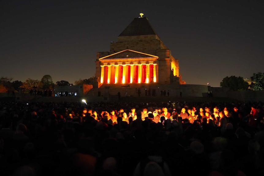 In the dark of the morning, crowds gather at Melbourne's Shrine of Remembrance.