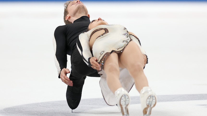 A man and a woman compete in an ice skating competition