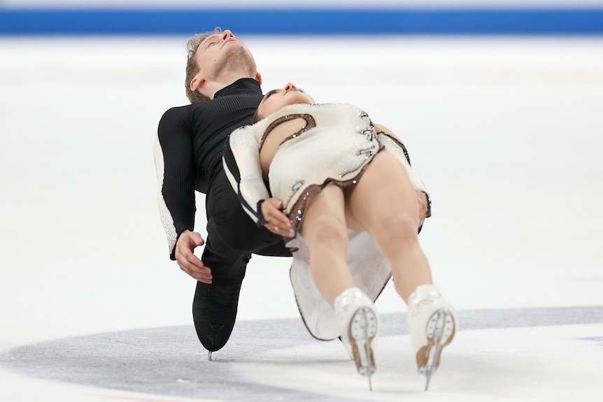 A man and a woman compete in an ice skating competition
