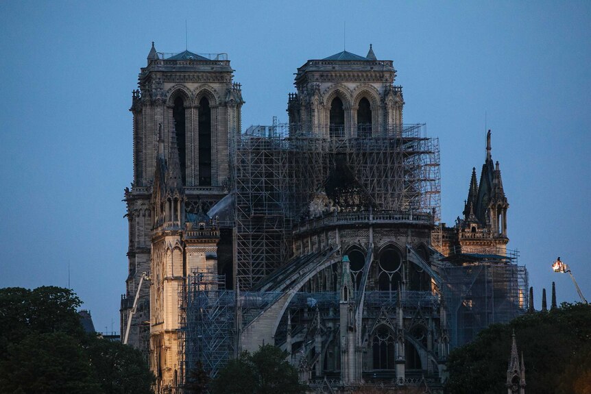 Fire fighters spray water on the Notre Dame cathedral in the early morning after the fire.