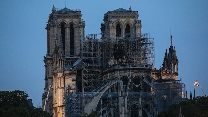 Fire fighters spray water on the Notre Dame cathedral in the early morning after the fire.