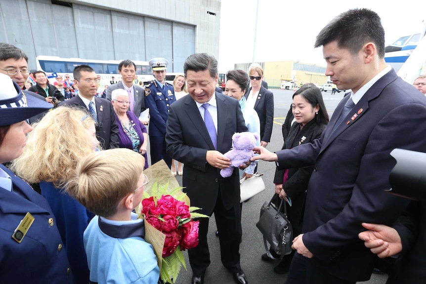President Xi receives his lavender bear on arrival at Hobart Airport.