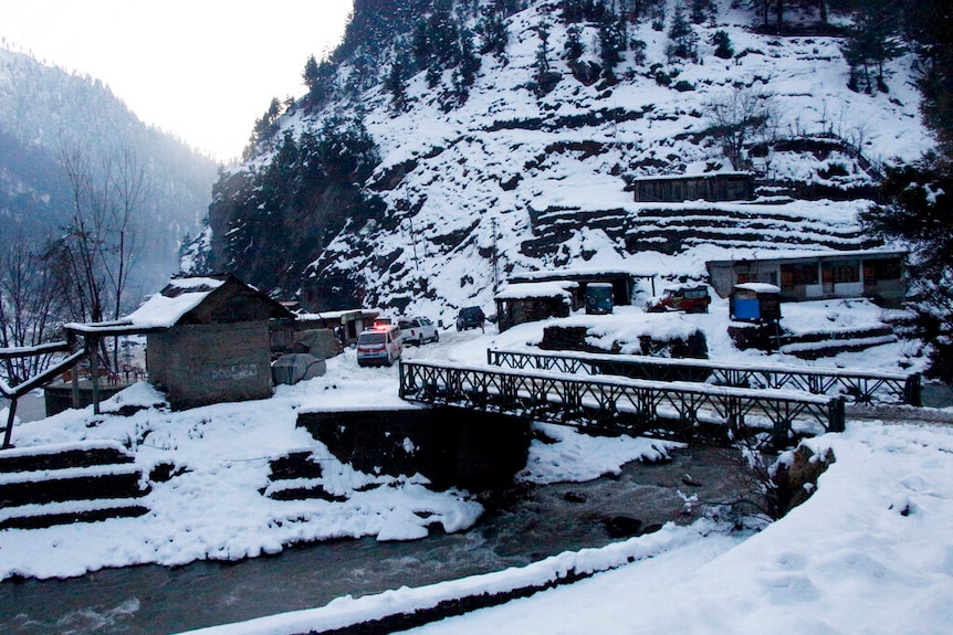 An ambulance is stranded in a mountainous village covered with snow