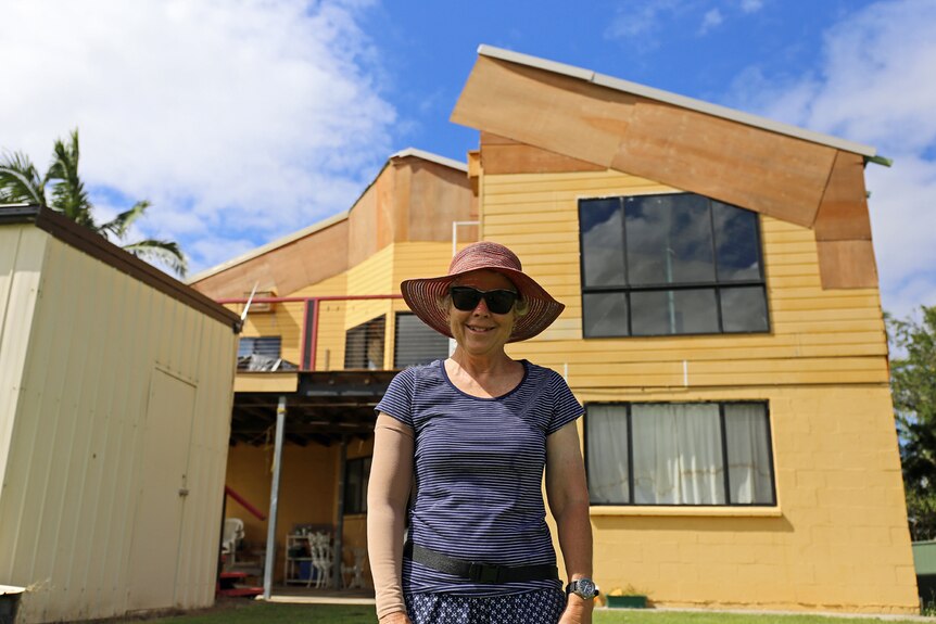 Julie Hardy in front of her Palmers Island home that was severely storm-damaged