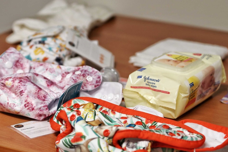 Baby nappies and wipes on a table.