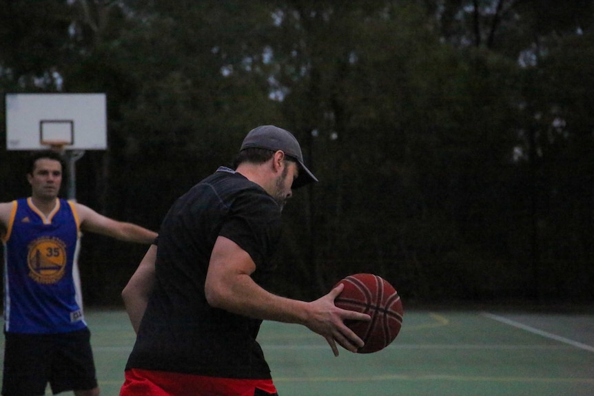Labor MP Ed Husic dribbles the ball in a basketball game at Parliament House.