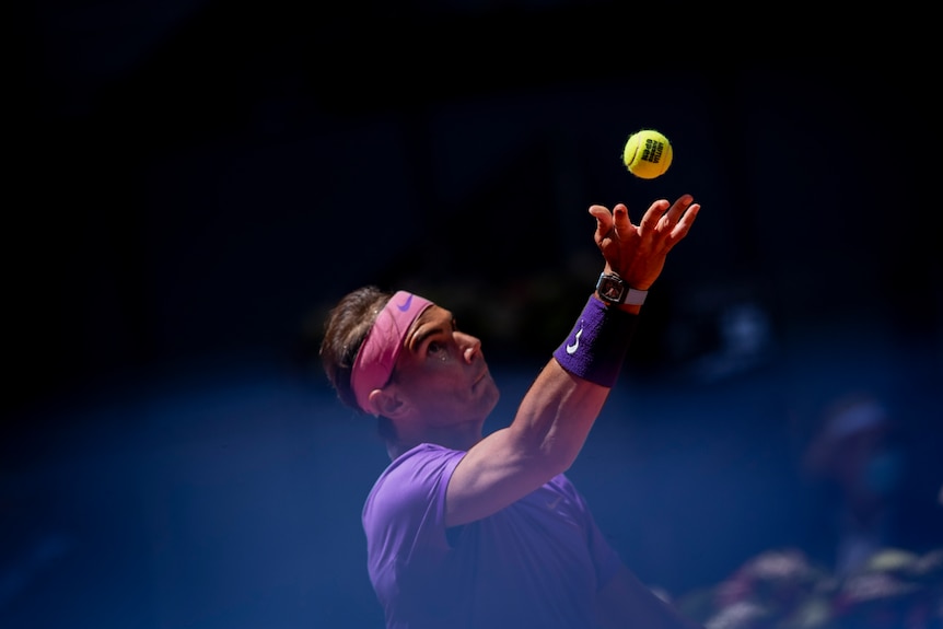 Rafael Nadal early in his ball toss while serving.