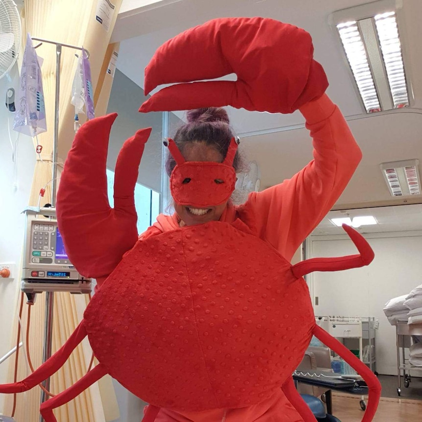 A woman in a crab costume undergoing chemotherapy