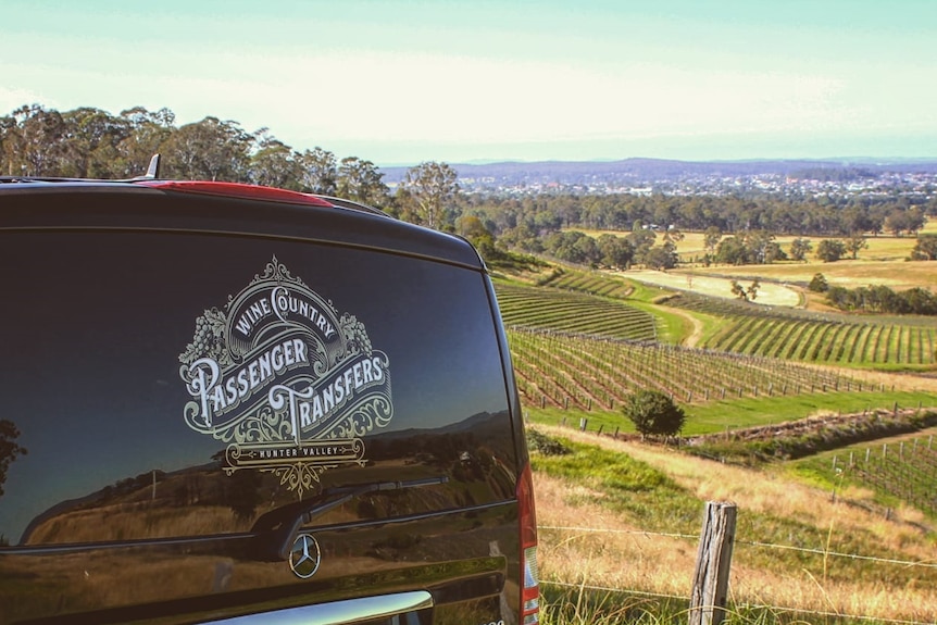 a van with a winery background