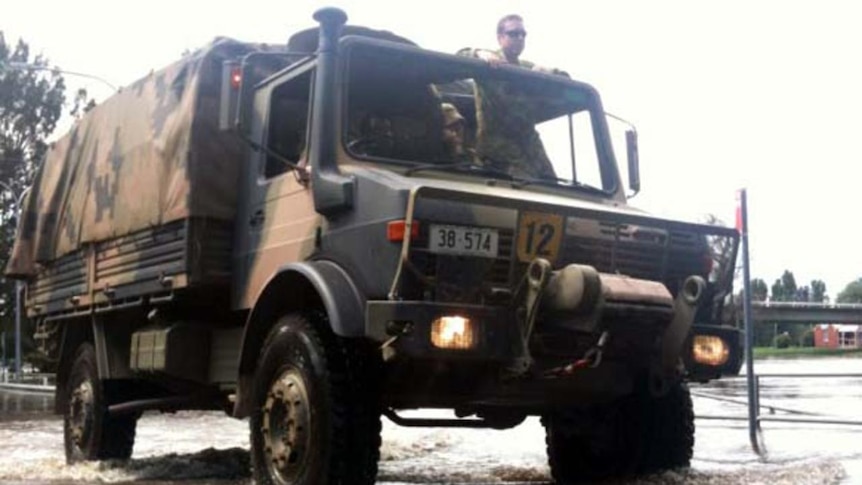 An army truck drives through floodwaters