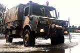 An army truck drives through floodwaters