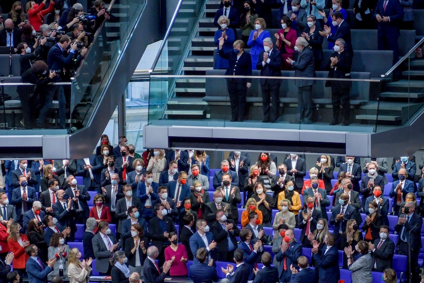 Politicians applaud in the Germany legislature