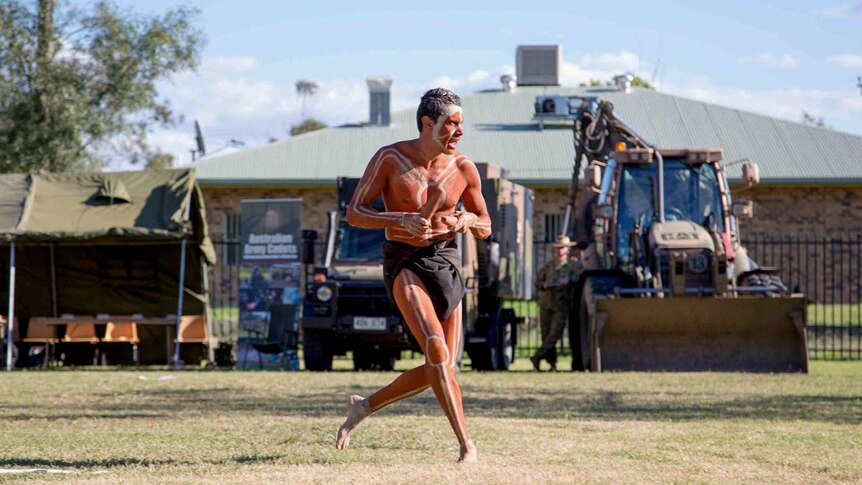 Aboriginal dancer performing at an event welcoming the army to Toomelah