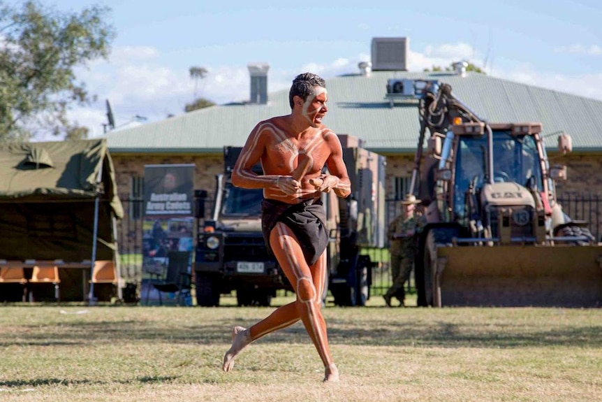 Aboriginal dancer performing at an event welcoming the army to Toomelah