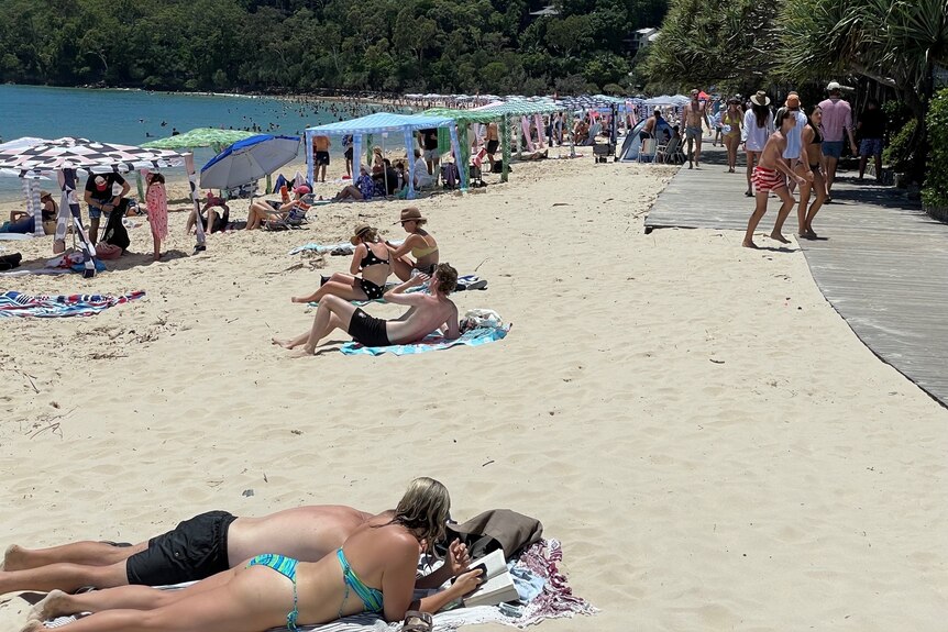Beach at Noosa packed with holidaymakers on Queensland's Sunshine Coast during the COVID-19 pandemic