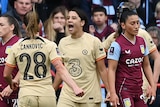 Sam Kerr shouts as Chelsea teammates run to celebrate with her after a goal against Aston Villa.