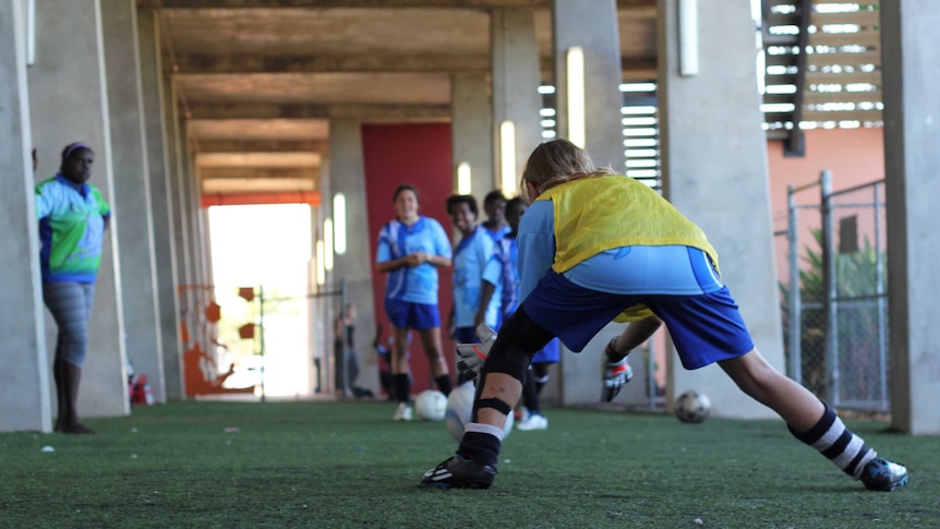 A group of young girls play soccer.