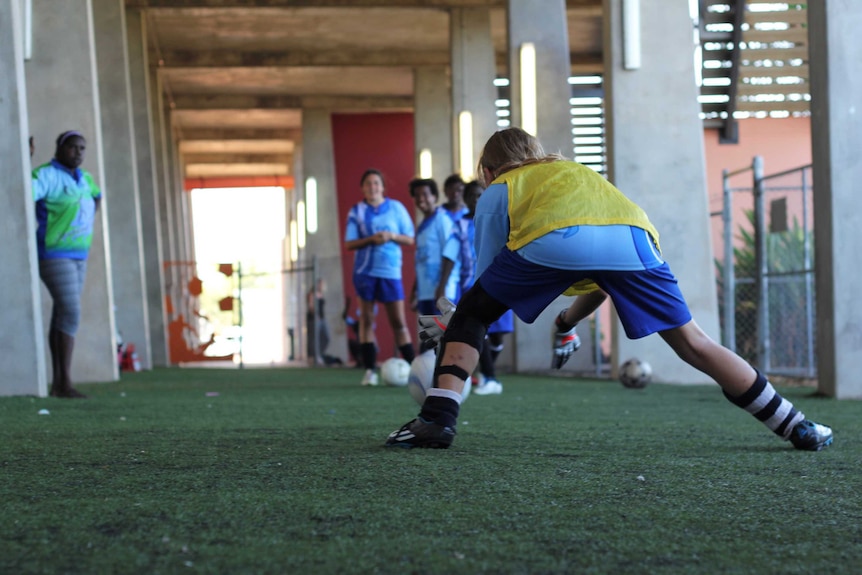 A group of young girls play soccer.