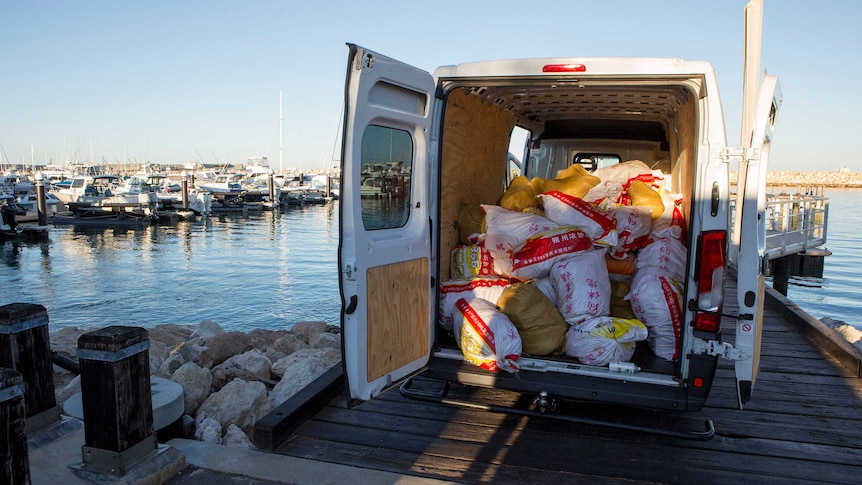 A van with its back doors open with a cargo of bags containing meth, at Geraldton harbour.