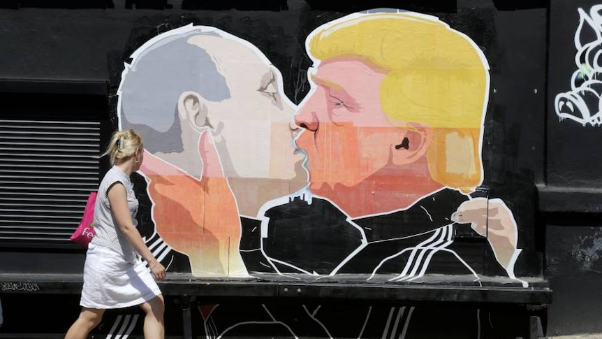 lady walks past graffiti of Trump and Putin kissing