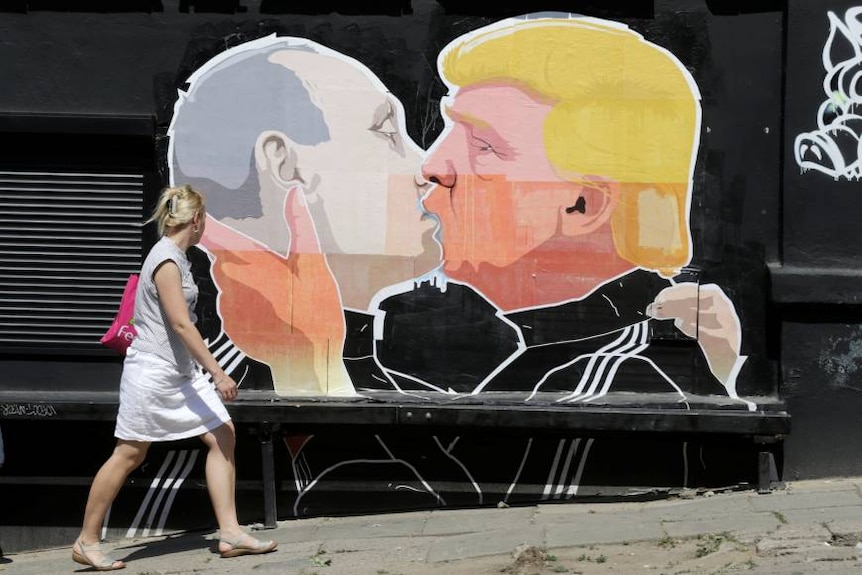 lady walks past graffiti of Trump and Putin kissing