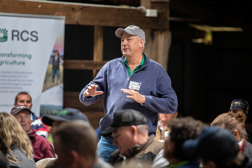 A man standing up and speaking at an event