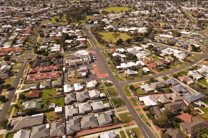 A drone shot of a regional suburb with houses and trees and playgrounds