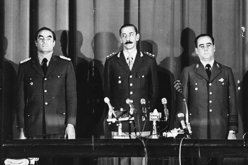 Black and white image of Emilio Massera, Jorge Videla And Orlando Agosti in 1976.