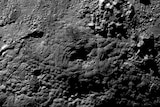 Mountainous hummocky terrain of Pluto's surface showing a giant caldera thought to belong to a four kilometre tall ice volcano.