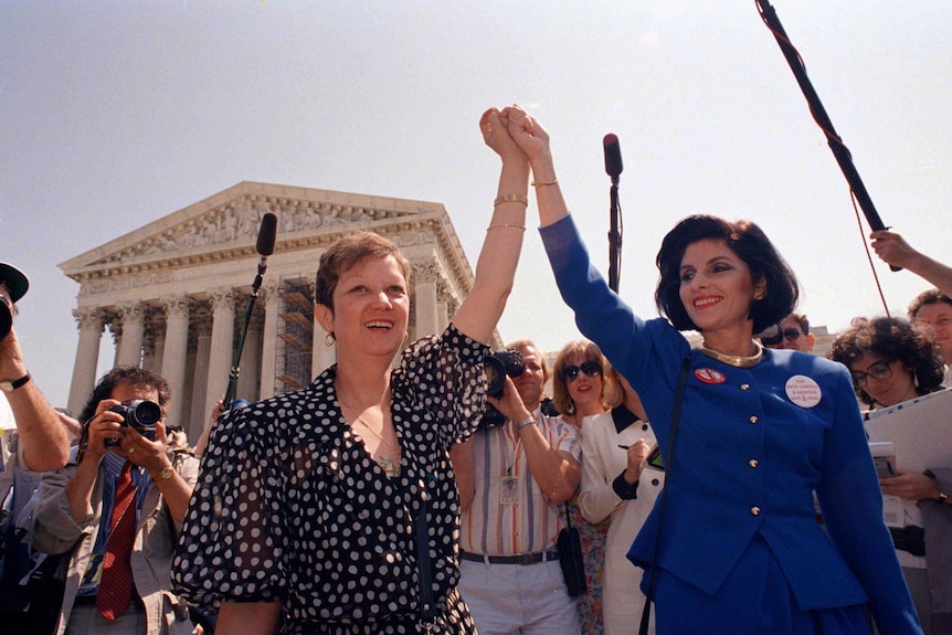 Norma McCorvey and her attorney Gloria Allred leave the Supreme Court in 1989