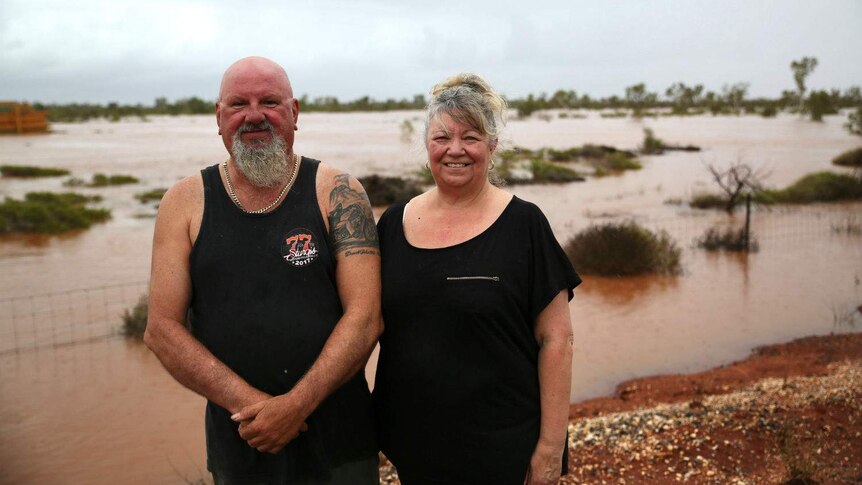 Peter Widdup and Jan Widdup-Breddy standing in front of flooded land.