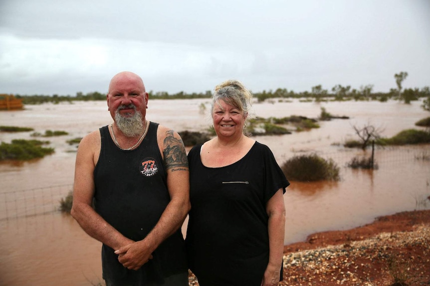 Peter Widdup and Jan Widdup-Breddy standing in front of flooded land.