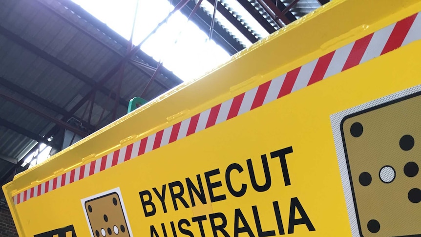 A picture of a 65 Tonne underground truck, built by Atlas Copco, with Byrnecut Mining logo on side