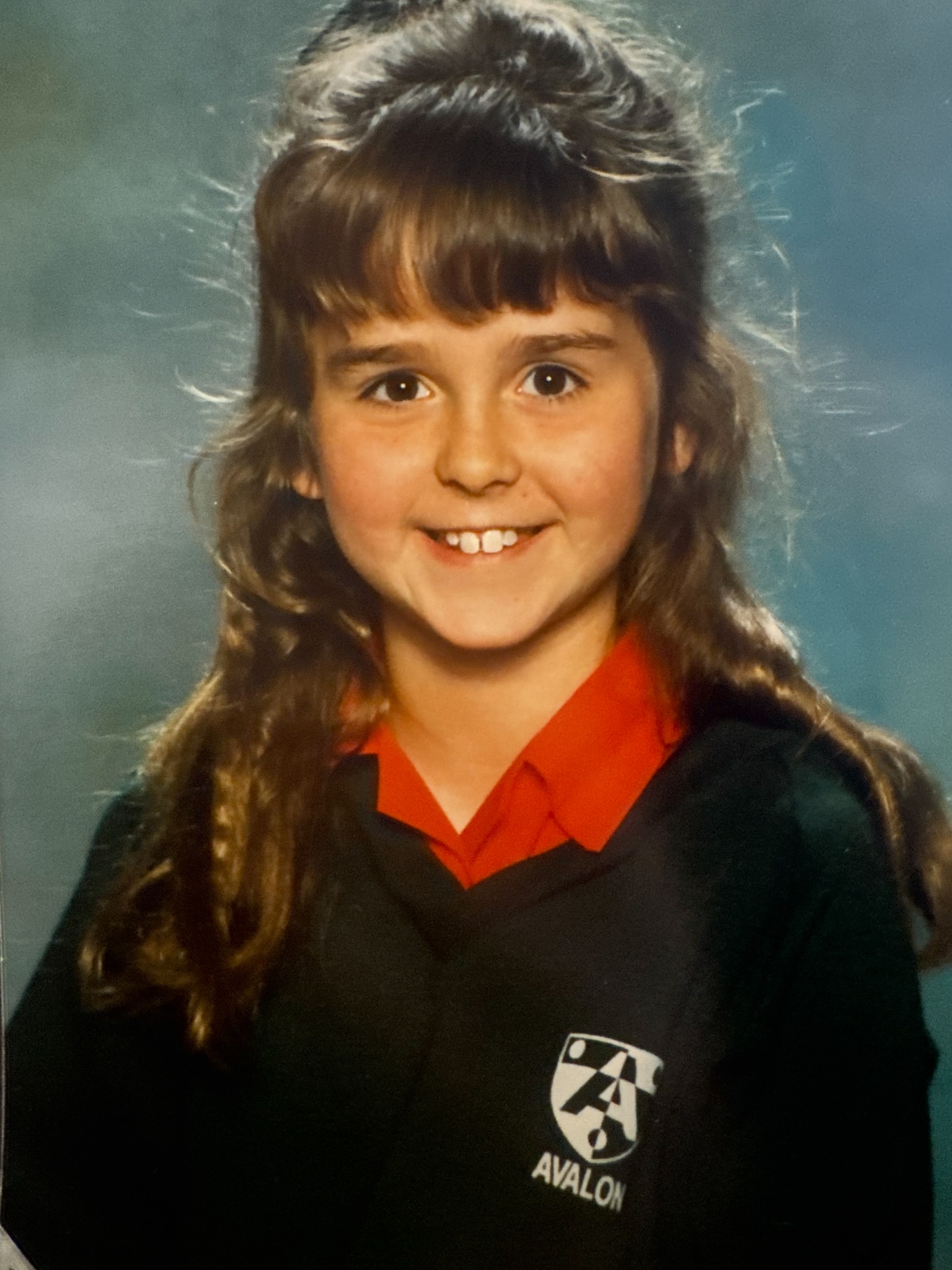 A female child smiles in her school photo