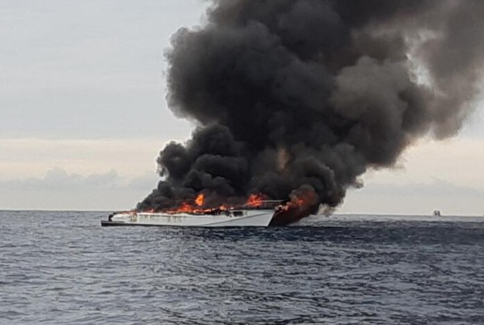 A boat on fire at sea