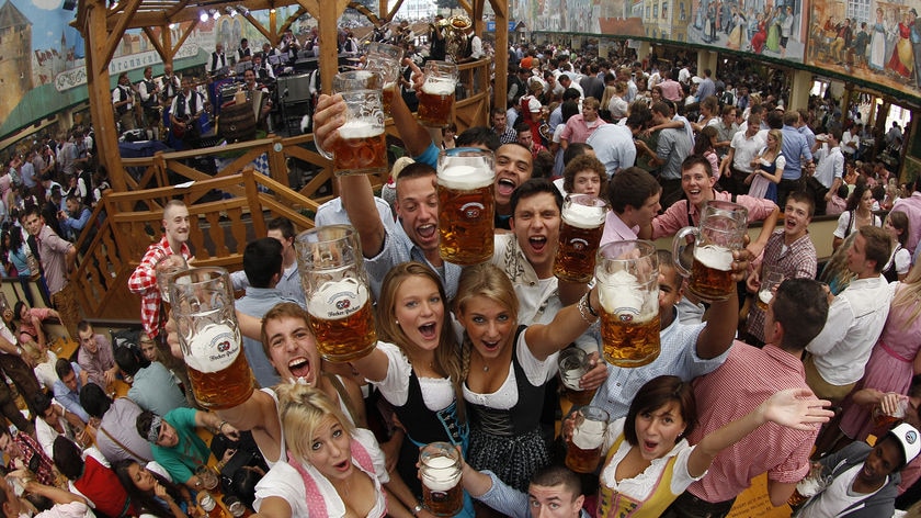 People toast with beer during the opening of Oktoberfest