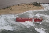 A giant ship washed up on a beach.
