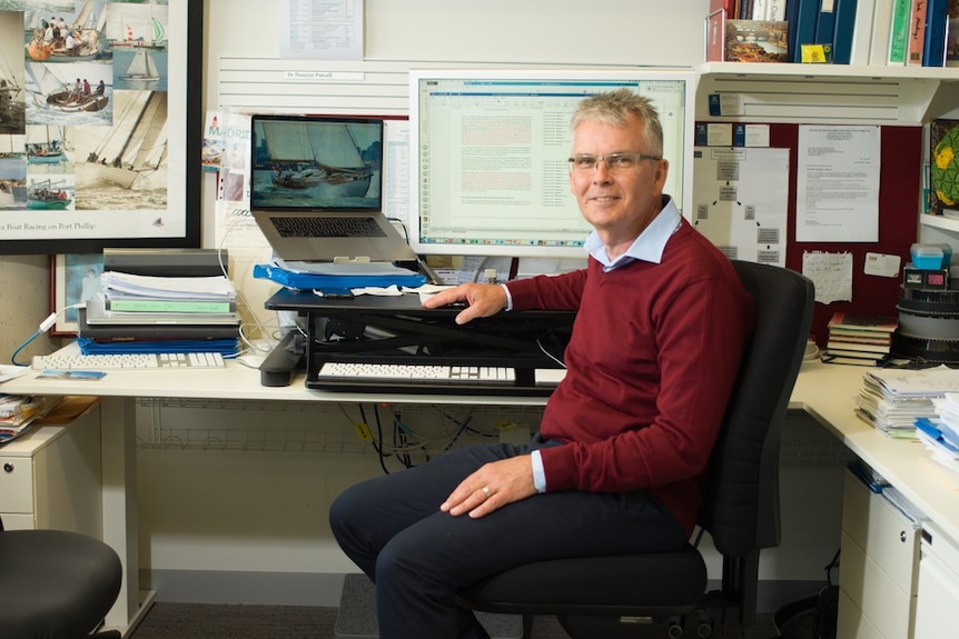 A middle aged man in an office environment.