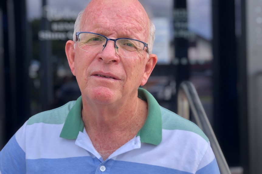 A man, wearing glasses, and a polo shirt